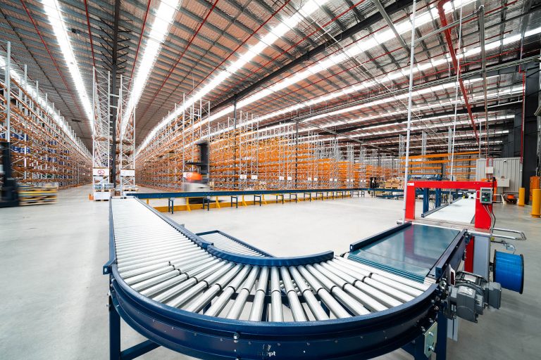 Blue color curved products conveyors placed in the warehouse