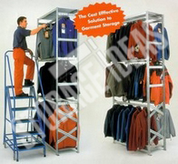 Man stand on the stair ladder and arranging shirts on the storage shelves